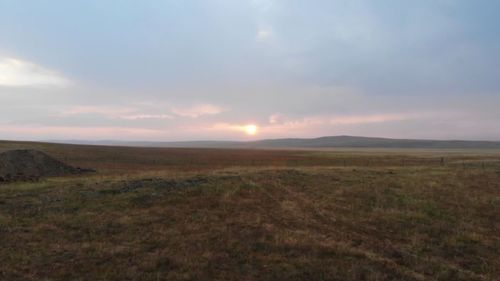 Scenic view of landscape against sky during sunset