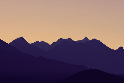 Scenic view of mountains against clear sky during sunset
