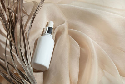 High angle view of moisturizer on textile