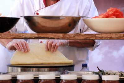 Midsection of male chef preparing food in kitchen