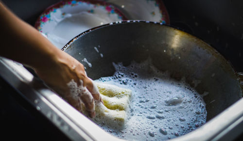 Midsection of person preparing food in kitchen