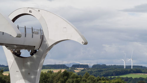 Close-up of wind turbine against sky