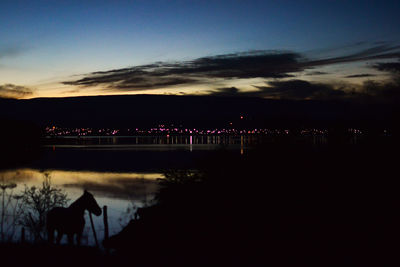 Scenic view of landscape against sky at dusk