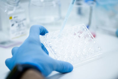 Low section of scientist examining chemical in laboratory