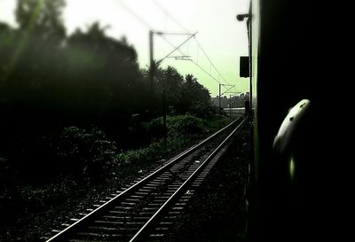 Railroad tracks amidst trees against sky