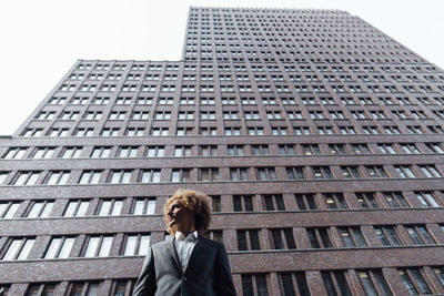 Thoughtful businessman standing at potsdamer platz