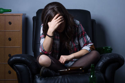 Midsection of woman sitting at home