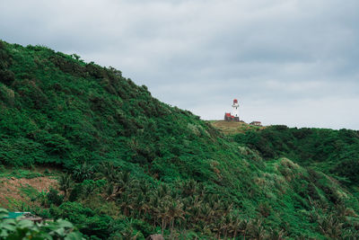 Lighthouse on land against sky