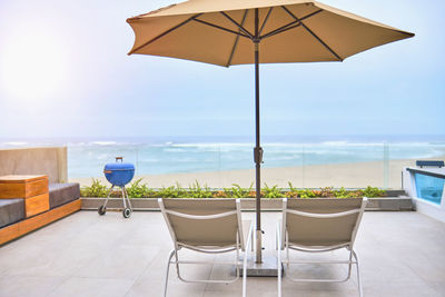 Rear view of woman with umbrella on table