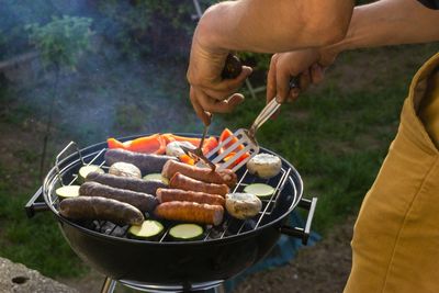 Man preparing food on barbecue grill