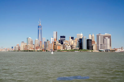 Modern buildings in city against clear sky