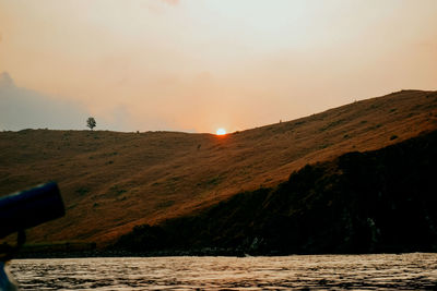 Scenic view of lake against sky during sunset