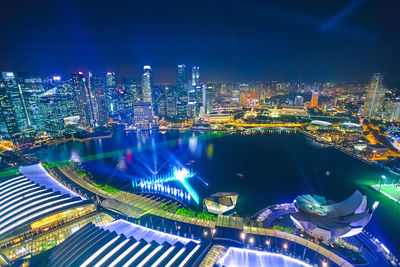 High angle view of illuminated buildings in city at night