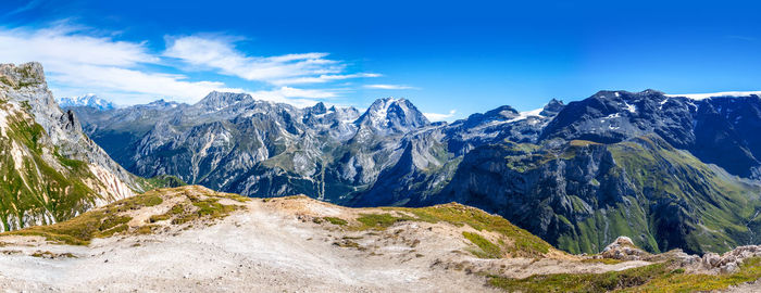 Scenic view of snowcapped mountains against blue sky