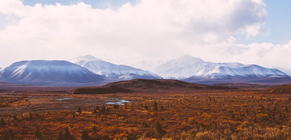 Scenic view of mountains against cloudy sky