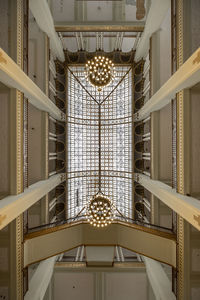 Low angle view of illuminated chandelier hanging from ceiling 