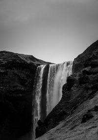 Scenic view of waterfall against clear sky