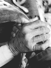 Close-up of senior people holding hands