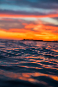 Scenic view of sea against orange sky