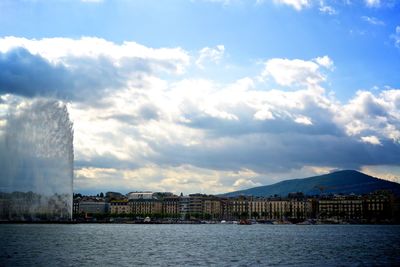 Buildings against cloudy sky
