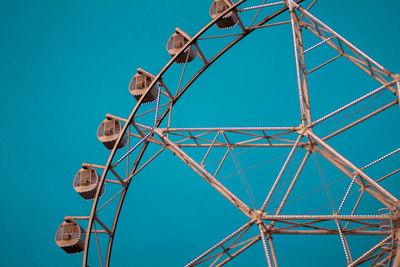 Low angle view of ferris wheel against clear blue sky