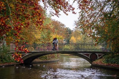 Couple in a bridge over river during autumn