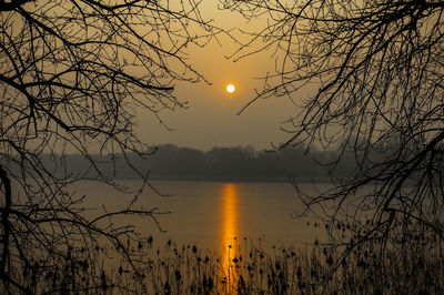 Scenic view of lake against sky during sunset