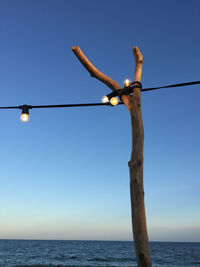 Low angle view of lighting equipment against clear sky