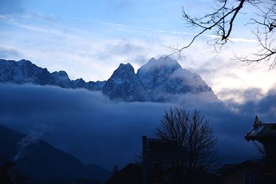 Scenic view of mountains against cloudy sky