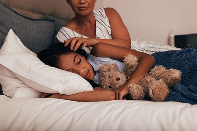 Young woman sleeping on bed at home