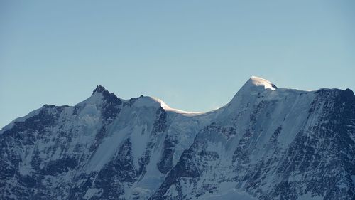 Scenic view of snowcapped mountains against clear sky