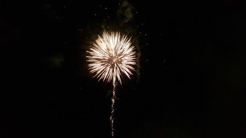 Low angle view of firework display at night