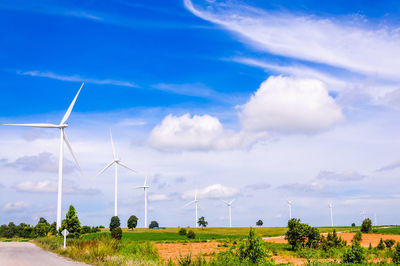 Windmill on field against sky