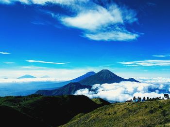 Scenic view of snowcapped mountains against blue sky