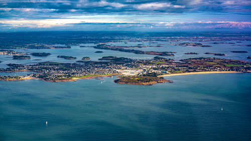 Aerial view of sea and city against sky