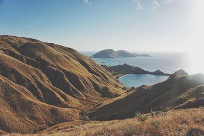 Scenic view of sea and mountains against sky