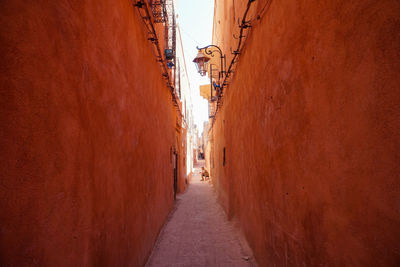 Lonely man sitting at the end of an alley in the city center of marrakesh