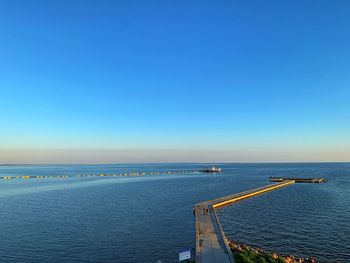 Scenic view of sea against clear blue sky