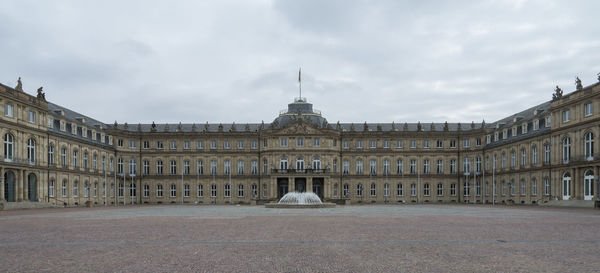 Buildings in city against cloudy sky