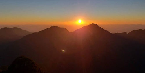 Scenic view of silhouette mountains against sky during sunset