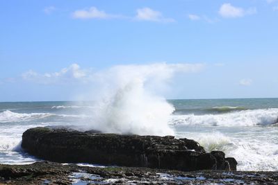 Waves breaking against sea