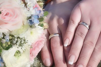Midsection of woman with pink roses