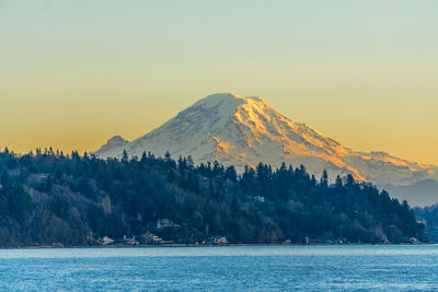 Mount rainier across the puget sound at twilight. photo taken from burien, washington.