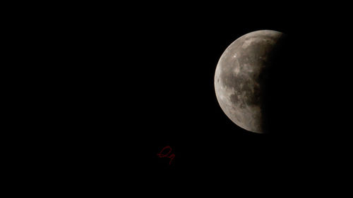 Low angle view of moon against sky at night