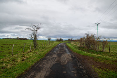 Road passing through landscape against sky