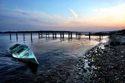 Pier on sea at sunset