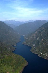 High angle view of river amidst mountains against sky