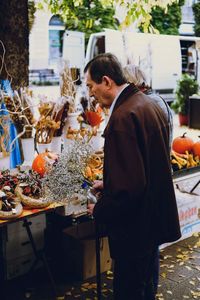 Man looking at food while standing at market