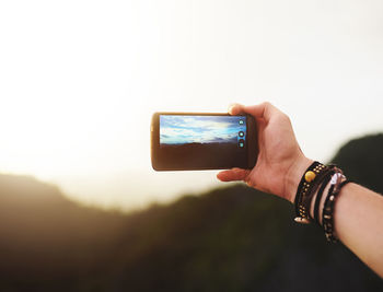 Cropped hand of woman holding mobile phone