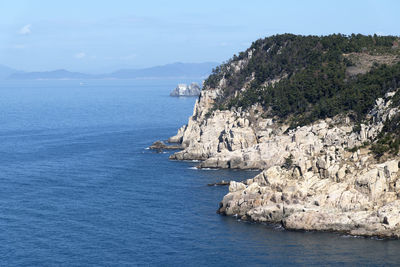 Scenic view of sea and mountains against sky